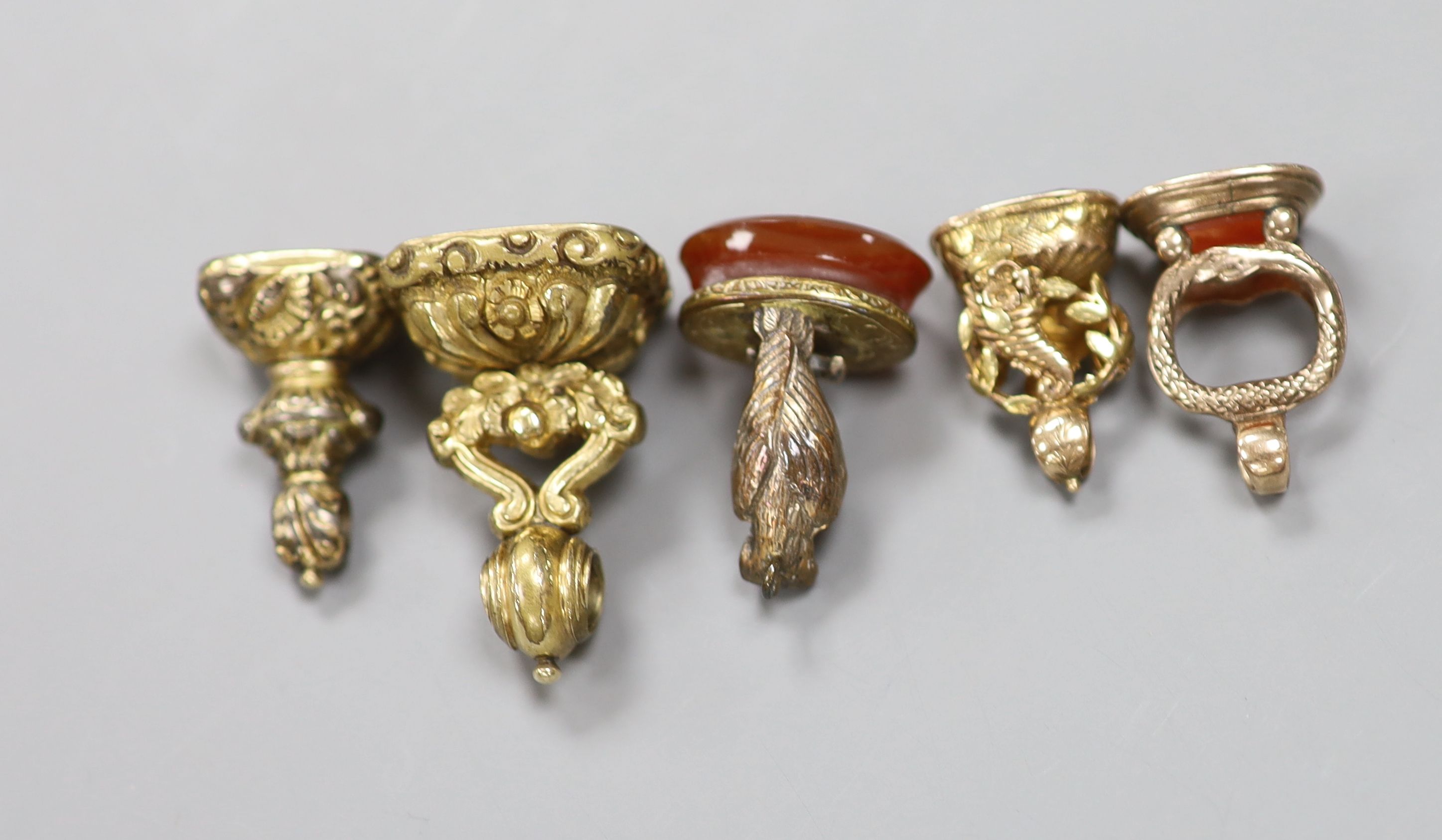 Five assorted 19ct century gilt or yellow metal overlaid and gem set fob seals, largest 31mm.